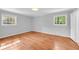 Bedroom features hardwood floors, neutral walls, and two bright, sun-filled windows at 4331 E Kings Point Circle, Dunwoody, GA 30338