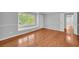 Spacious bedroom with hardwood floors, a window seat, and multiple doors at 4331 E Kings Point Circle, Dunwoody, GA 30338