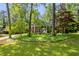 Landscaped front yard with mature trees framing this beautiful home in a park-like setting at 4331 E Kings Point Circle, Dunwoody, GA 30338