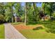 Beautiful home with brick exterior, lush landscaping, and a long driveway, surrounded by trees at 4331 E Kings Point Circle, Dunwoody, GA 30338