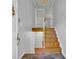 A bright entryway with hardwood stairs, tiled floor, and gray paint provides a warm welcome at 4331 E Kings Point Circle, Dunwoody, GA 30338