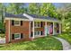 Charming two-story brick home featuring classic architecture, black shutters, and a welcoming front porch at 4331 E Kings Point Circle, Dunwoody, GA 30338