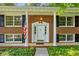 Classic brick home entrance featuring white columns, dark shutters, and decorative front door at 4331 E Kings Point Circle, Dunwoody, GA 30338