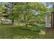 Landscaped front yard with an ornamental tree and other homes in the distance at 4331 E Kings Point Circle, Dunwoody, GA 30338