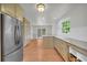 Charming kitchen with wood cabinets, stainless fridge, stone countertops, and hardwood floors at 4331 E Kings Point Circle, Dunwoody, GA 30338