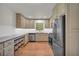Spacious kitchen with stainless appliances, stone countertops, and wood cabinets at 4331 E Kings Point Circle, Dunwoody, GA 30338