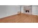 Bright living room features hardwood floors, brick fireplace, and built-in bookshelves at 4331 E Kings Point Circle, Dunwoody, GA 30338