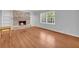 Cozy living room with hardwood floors and a brick fireplace with built-in shelves at 4331 E Kings Point Circle, Dunwoody, GA 30338