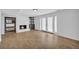 Basement living room features a fireplace, tile floors, and glass doors to the backyard at 4331 E Kings Point Circle, Dunwoody, GA 30338