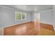Sunlit living room with hardwood floors and a large window, perfect for relaxing at 4331 E Kings Point Circle, Dunwoody, GA 30338