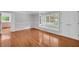 Sun-drenched living area featuring gleaming hardwood floors, neutral paint, and large windows at 4331 E Kings Point Circle, Dunwoody, GA 30338