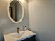 Bathroom featuring a modern vanity, stylish fixtures, and an oval mirror at 5536 Strathmoor Manor Cir, Lithonia, GA 30058