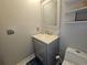 Updated half bathroom with modern vanity, white countertop, and stylish fixtures at 5536 Strathmoor Manor Cir, Lithonia, GA 30058