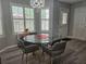 Charming dining space with a glass table, four chairs, and plantation shutters at 5536 Strathmoor Manor Cir, Lithonia, GA 30058