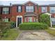 Traditional brick townhome with a well-manicured lawn and black shutters at 5536 Strathmoor Manor Cir, Lithonia, GA 30058