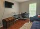 Bright home office with a large desk, television, and a comfortable sitting area at 5536 Strathmoor Manor Cir, Lithonia, GA 30058