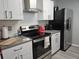 Modern kitchen featuring stainless steel appliances, white cabinets, and gray countertops at 5536 Strathmoor Manor Cir, Lithonia, GA 30058