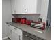 Well-lit kitchen showcasing grey countertops and ample cabinet space at 5536 Strathmoor Manor Cir, Lithonia, GA 30058