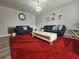 A spacious living room with bright red rug and comfortable seating arrangement at 5536 Strathmoor Manor Cir, Lithonia, GA 30058
