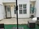 Cozy patio with seating, grill, privacy fence, and a combination of concrete and artificial turf at 5536 Strathmoor Manor Cir, Lithonia, GA 30058