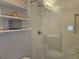 Modern bathroom with walk-in glass shower, sleek shelving, and contemporary fixtures at 5536 Strathmoor Manor Cir, Lithonia, GA 30058