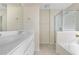 Bathroom features dual sinks, white cabinets, a glass-enclosed shower, and a soaking tub at 7812 Kiverton Pl, Atlanta, GA 30350
