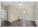 Spacious bedroom with hardwood floors, a ceiling fan, and two doors at 7812 Kiverton Pl, Atlanta, GA 30350