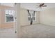 Spacious, carpeted bedroom with window, ceiling fan, and doorway to another room at 7812 Kiverton Pl, Atlanta, GA 30350