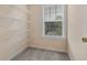Walk-in closet space with adjustable white shelving near a window at 7812 Kiverton Pl, Atlanta, GA 30350