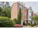 Brick townhome showcasing its architectural details, landscaping, and attached garage at 7812 Kiverton Pl, Atlanta, GA 30350