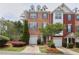 Charming brick townhome with attached garage, manicured landscaping, and inviting curb appeal at 7812 Kiverton Pl, Atlanta, GA 30350