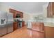 Eat-in kitchen features granite countertops, stainless steel appliances, and rich wood cabinets at 7812 Kiverton Pl, Atlanta, GA 30350