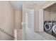 Upstairs landing featuring a side-by-side washer and dryer and hallway leading to a bedroom at 7812 Kiverton Pl, Atlanta, GA 30350
