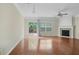 Bright living room boasts hardwood floors, fireplace, ceiling fan, and access to a deck with wooded views at 7812 Kiverton Pl, Atlanta, GA 30350