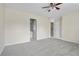 Large, carpeted main bedroom with ceiling fan, and doors to the bathroom and closet at 7812 Kiverton Pl, Atlanta, GA 30350