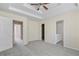 Spacious main bedroom features a tray ceiling, neutral carpet, and an ensuite bathroom at 7812 Kiverton Pl, Atlanta, GA 30350