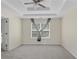 Spacious main bedroom features a tray ceiling, neutral carpet, and lots of natural light at 7812 Kiverton Pl, Atlanta, GA 30350