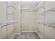 Spacious walk-in closet featuring adjustable white shelving and ample storage space at 7812 Kiverton Pl, Atlanta, GA 30350