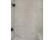 This tiled shower features modern shower head and fixtures at 117 Spring St, Stockbridge, GA 30281