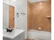 Clean bathroom features a modern vanity, mirror and shower-tub combo at 117 Spring St, Stockbridge, GA 30281
