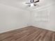 This bedroom features new hardwood floors, modern ceiling fan and a large window at 117 Spring St, Stockbridge, GA 30281