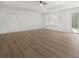 Large bedroom with new flooring, recessed ceiling, modern ceiling fan, and bright natural light at 117 Spring St, Stockbridge, GA 30281