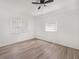 Bright bedroom features light-colored wood floors, two windows, and ceiling fan at 117 Spring St, Stockbridge, GA 30281