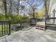 View of a spacious deck with black railings and steps leading to the backyard at 117 Spring St, Stockbridge, GA 30281