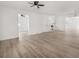 Bright, expansive living room with new light wood-look flooring, and fresh white paint at 117 Spring St, Stockbridge, GA 30281