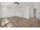 Bright main bedroom features hardwood floors, ceiling fan and a modern ensuite bathroom at 117 Spring St, Stockbridge, GA 30281