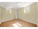 This bedroom features wood look floors, a white door and two windows at 2703 Flagstone Se Dr, Atlanta, GA 30316