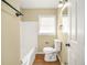 Bathroom with a white tub, toilet, and beige walls at 2703 Flagstone Se Dr, Atlanta, GA 30316