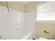 Bathroom with a white tiled tub and beige walls at 2703 Flagstone Se Dr, Atlanta, GA 30316
