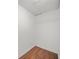 Small closet with laminate flooring, white walls, shelving and a textured tile ceiling at 2703 Flagstone Se Dr, Atlanta, GA 30316